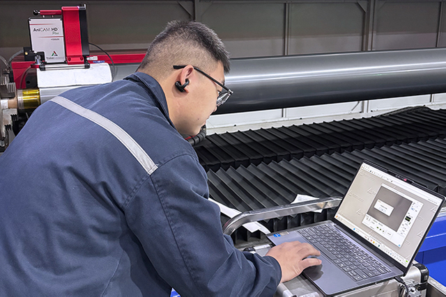 technician measuring anilox roller size tolerance in quality control room